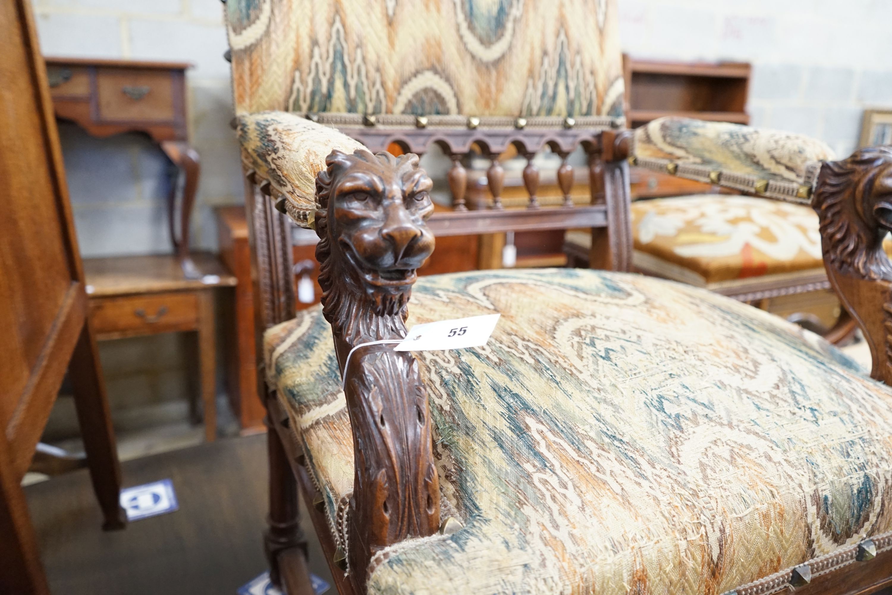 An early 20th century French walnut elbow chair with carved lion head arms, width 63cm, depth 60cm, height 106cm